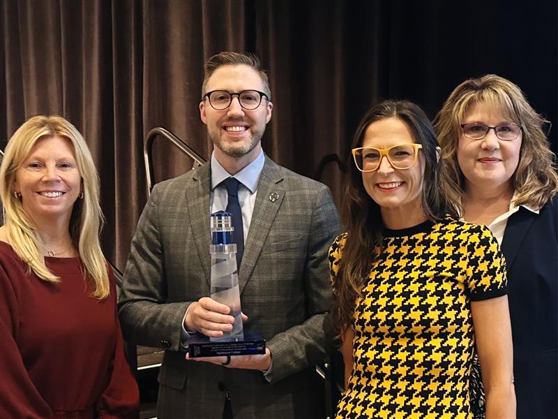 Nightingale College employees holding award