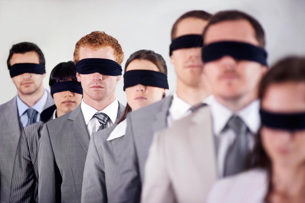7 people with blindfolds on wearing suits